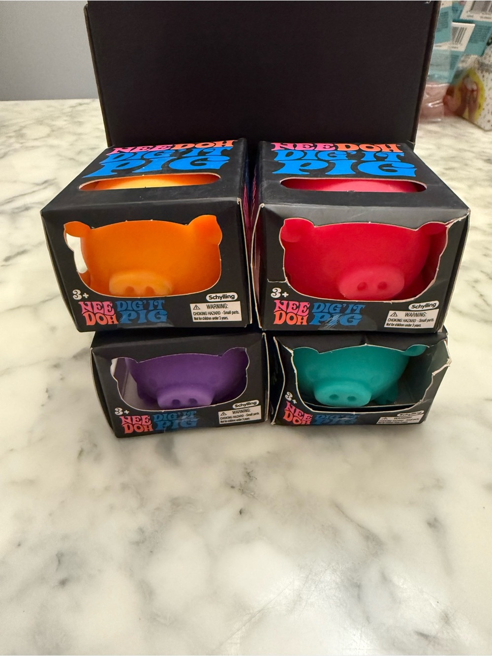 Schylling NeeDough Pig Sensory Toy - Orange, Red, Purple, Teal